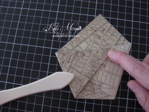 Take the other lower corner of the triangle and fold it over to the middle of the opposite side.